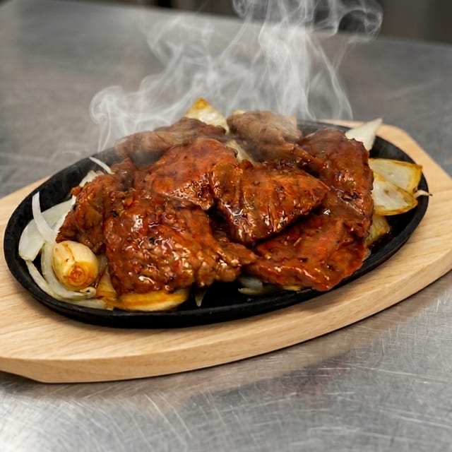 Sizzling Baby Cow Rib with Black Pepper Sauce.